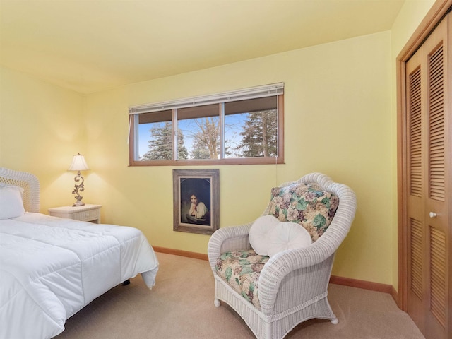 bedroom featuring carpet, a closet, and baseboards