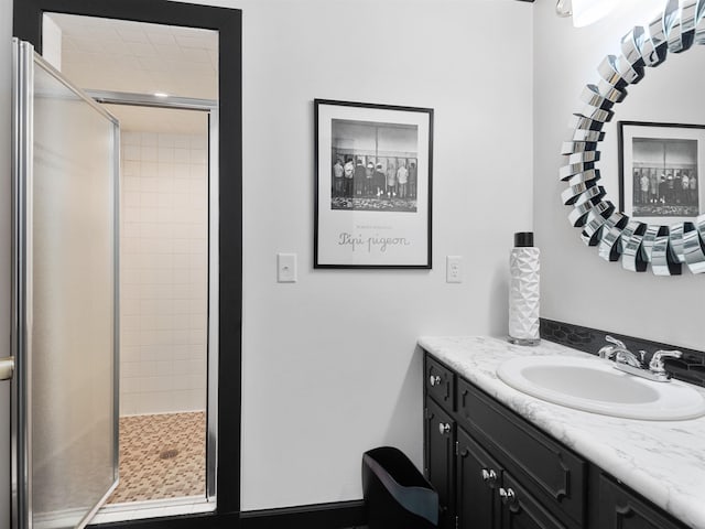 bathroom with a stall shower and vanity