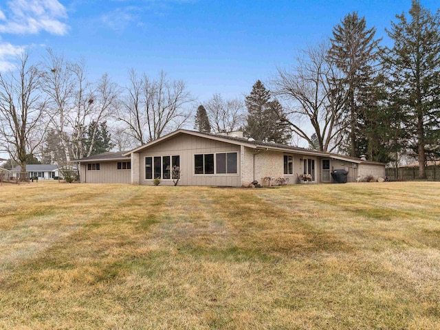 rear view of property featuring a yard