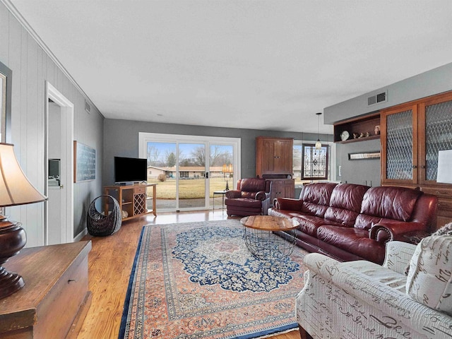 living room featuring light wood finished floors and visible vents