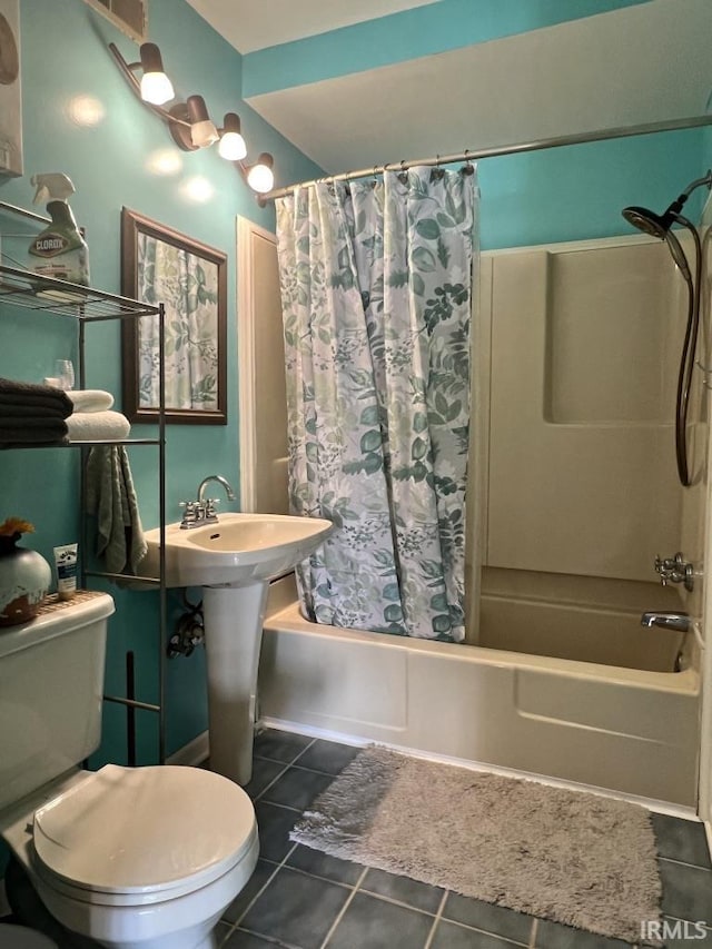 bathroom with a sink, shower / bath combo, tile patterned flooring, and toilet