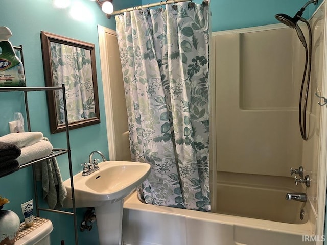 bathroom featuring shower / bath combo and toilet