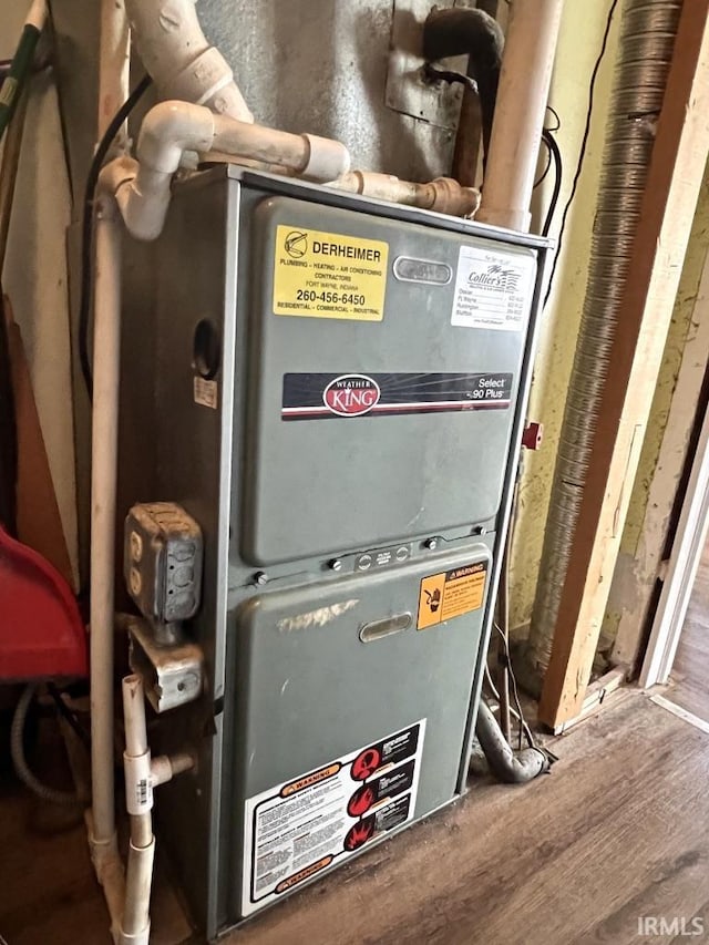 utility room featuring heating unit