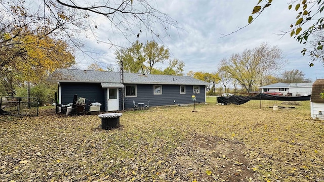 rear view of house featuring fence