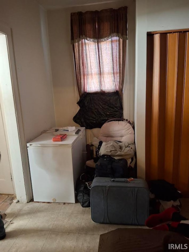 laundry area with light tile patterned floors