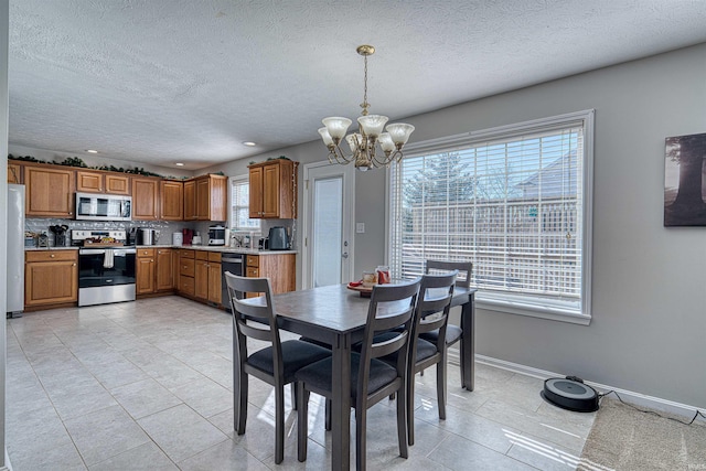 dining area with light tile patterned floors, baseboards, a textured ceiling, a chandelier, and recessed lighting