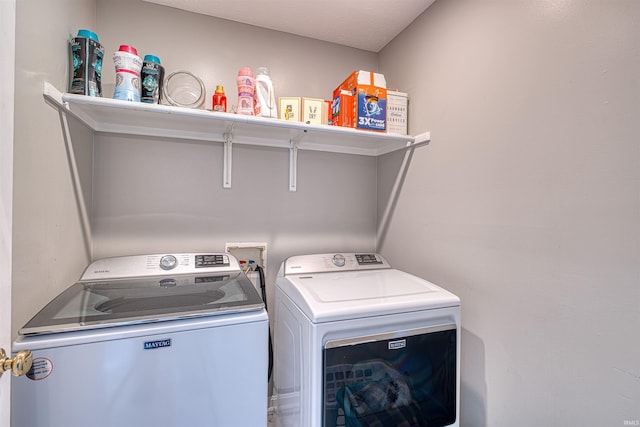 washroom with laundry area and independent washer and dryer