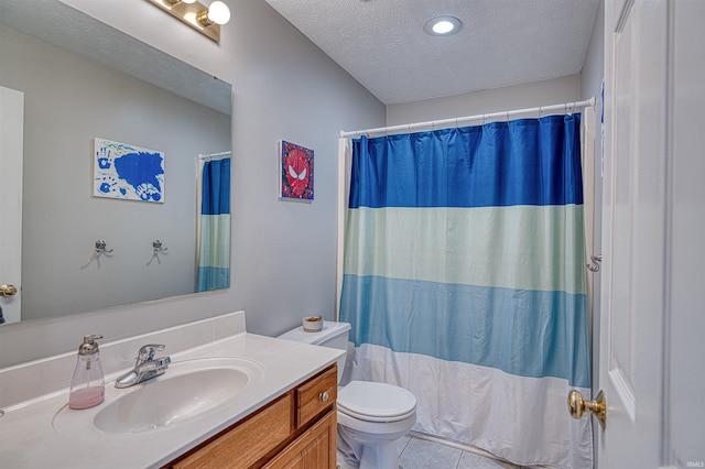 bathroom featuring toilet, curtained shower, tile patterned flooring, a textured ceiling, and vanity