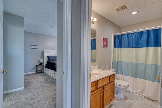 full bath featuring a textured ceiling, tile patterned flooring, toilet, vanity, and visible vents