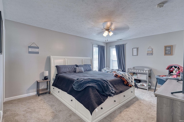 bedroom with light carpet, visible vents, baseboards, and a ceiling fan