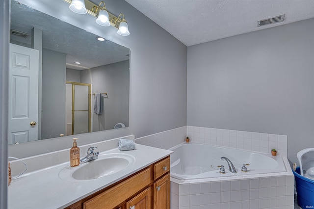 full bath with a jetted tub, a shower stall, visible vents, and vanity