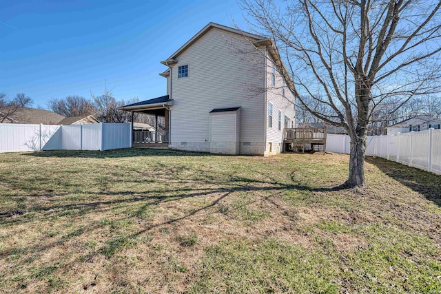 back of house with crawl space, a fenced backyard, a deck, and a lawn