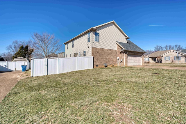 view of home's exterior with brick siding, a yard, a gate, crawl space, and fence