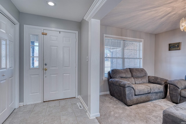 entryway with a healthy amount of sunlight, visible vents, baseboards, and light tile patterned flooring