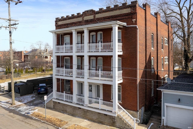 view of front of home featuring covered porch and brick siding