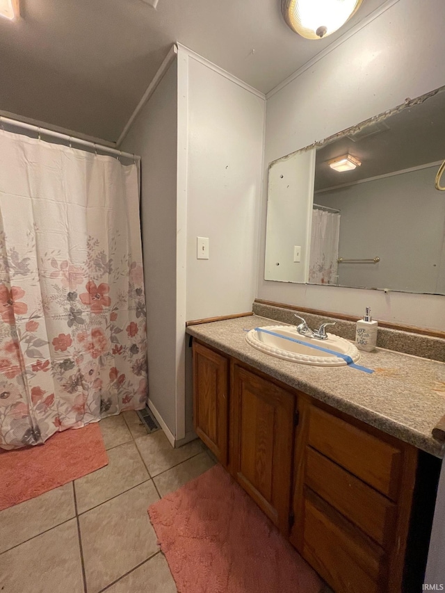 full bathroom featuring tile patterned flooring, crown molding, vanity, and curtained shower