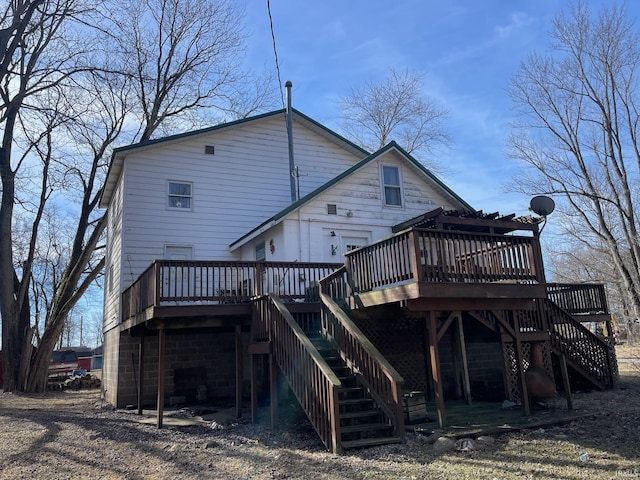 rear view of property featuring a deck and stairway