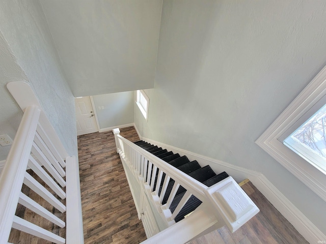 stairs featuring baseboards and wood finished floors