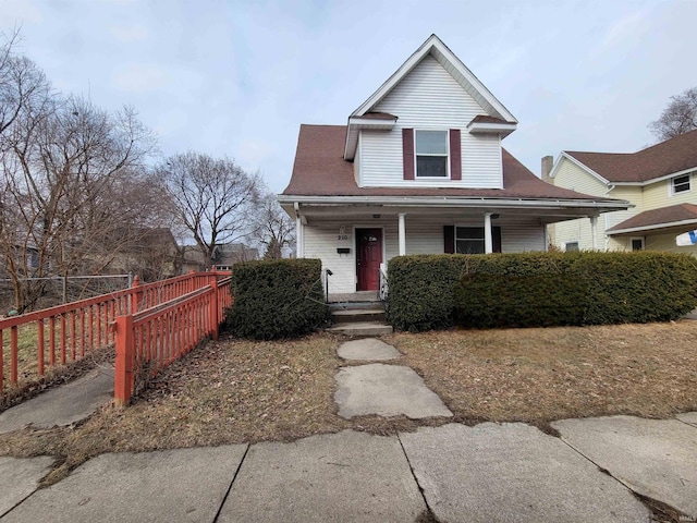 view of front of property featuring a porch and fence