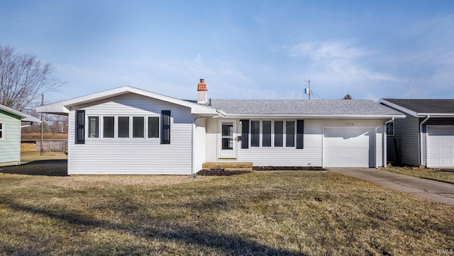 ranch-style home featuring a garage, concrete driveway, a shingled roof, and a front yard