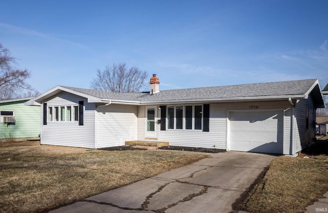 ranch-style house featuring a shingled roof, concrete driveway, a chimney, an attached garage, and a front yard