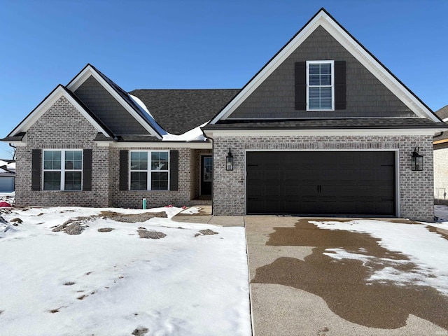 craftsman-style home with driveway and brick siding