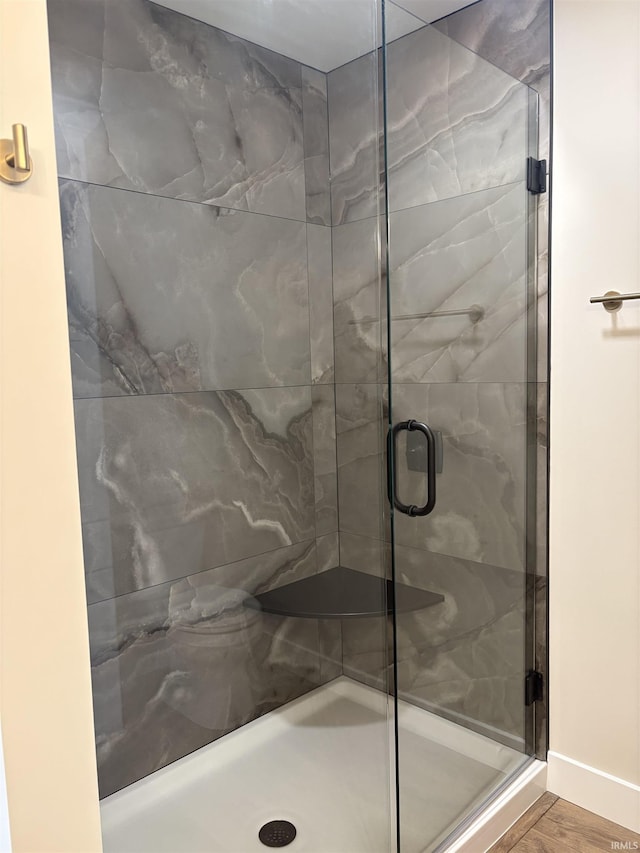 bathroom featuring a stall shower and baseboards