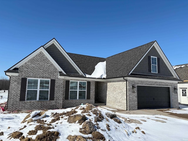 view of front of house with a garage and brick siding