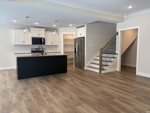 kitchen featuring stainless steel appliances, dark wood-style flooring, white cabinets, light countertops, and tasteful backsplash