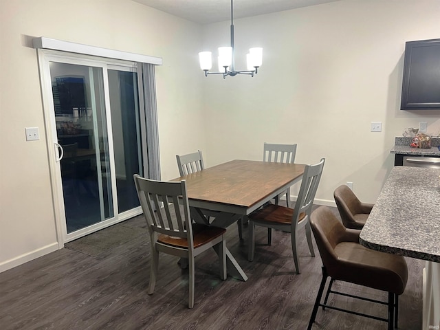 dining area featuring a chandelier, dark wood-style flooring, and baseboards