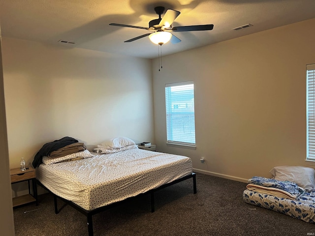 bedroom with ceiling fan, carpet, visible vents, and baseboards