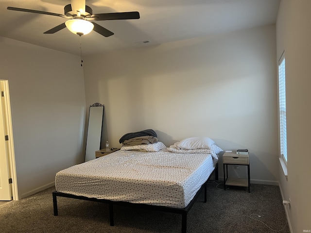 carpeted bedroom with a ceiling fan and baseboards