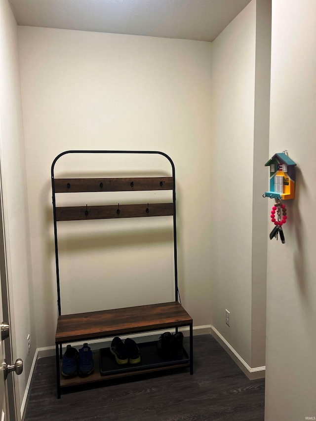 bedroom featuring baseboards and dark wood-style flooring