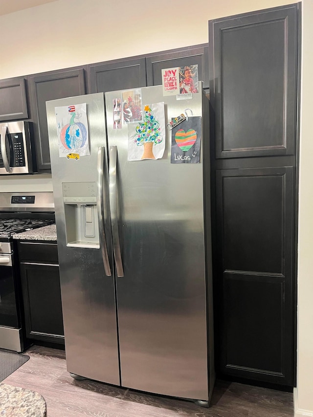 kitchen featuring stainless steel appliances and wood finished floors