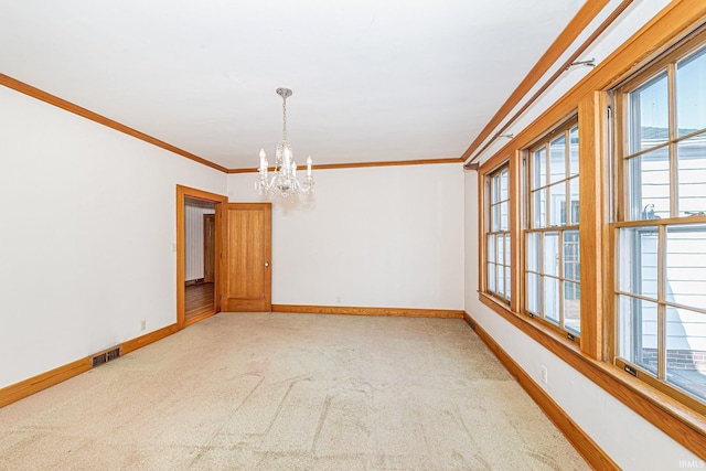 empty room with ornamental molding, a healthy amount of sunlight, visible vents, and baseboards