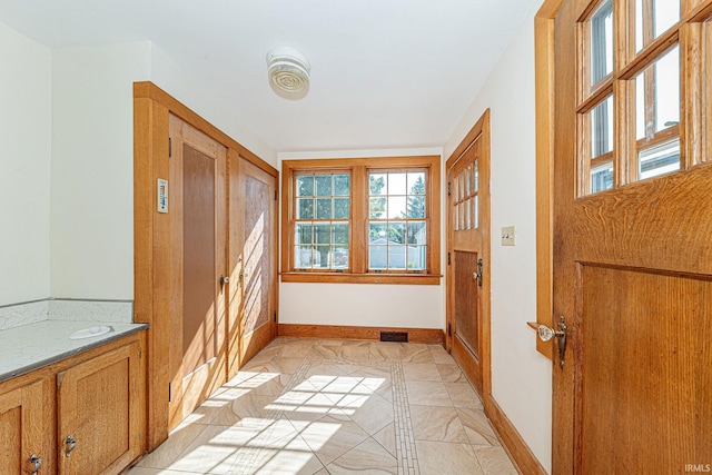 doorway to outside featuring visible vents and baseboards