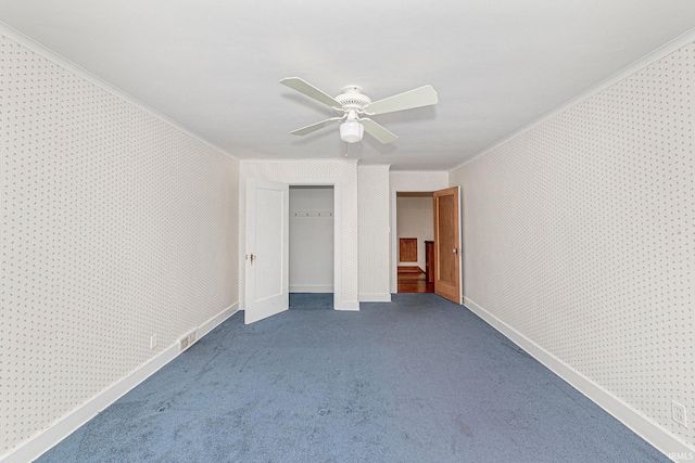 unfurnished bedroom featuring crown molding, carpet flooring, ceiling fan, baseboards, and wallpapered walls