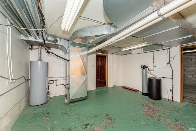 unfinished basement featuring water heater and heating unit