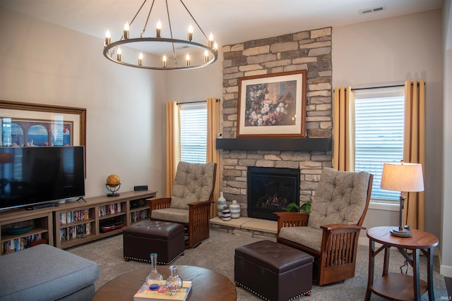 carpeted living area featuring a stone fireplace and visible vents