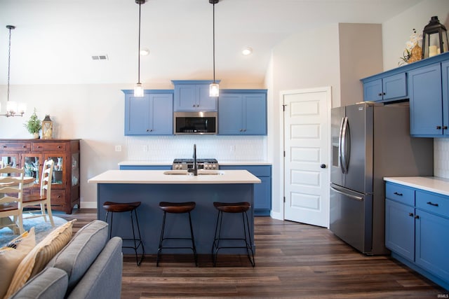 kitchen featuring appliances with stainless steel finishes, blue cabinets, a sink, and visible vents