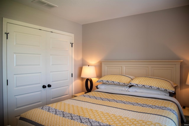 bedroom with a closet and visible vents