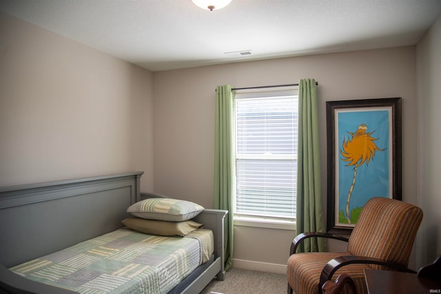 bedroom featuring light carpet, visible vents, and baseboards