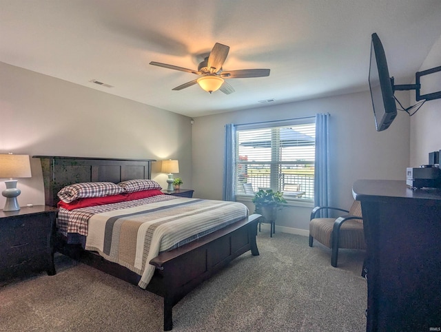 carpeted bedroom with baseboards, visible vents, and a ceiling fan