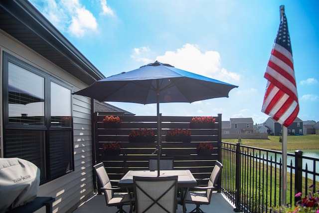 deck featuring a grill and outdoor dining space