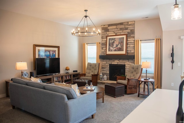 carpeted living area featuring visible vents, a fireplace, and a chandelier