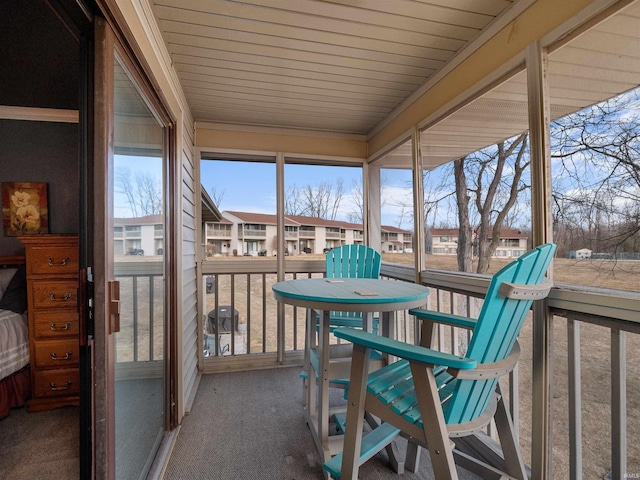 sunroom featuring a residential view