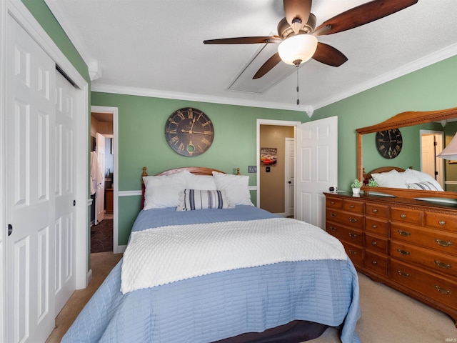 bedroom featuring crown molding, ceiling fan, a closet, and light colored carpet