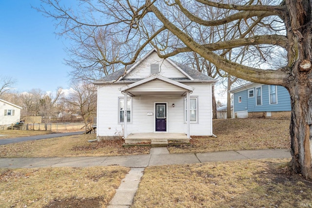 view of front of property featuring a porch and a shingled roof