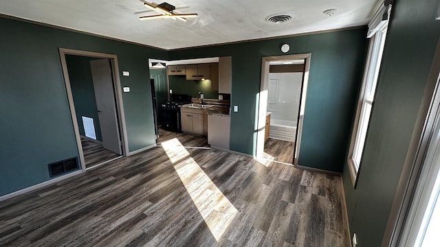 kitchen with visible vents, dark wood finished floors, and a sink