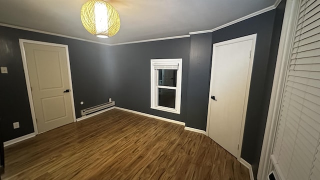 empty room with a baseboard radiator, baseboards, crown molding, and wood finished floors